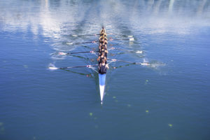 44248467 - rowers in eight-oar rowing boats on the tranquil lake